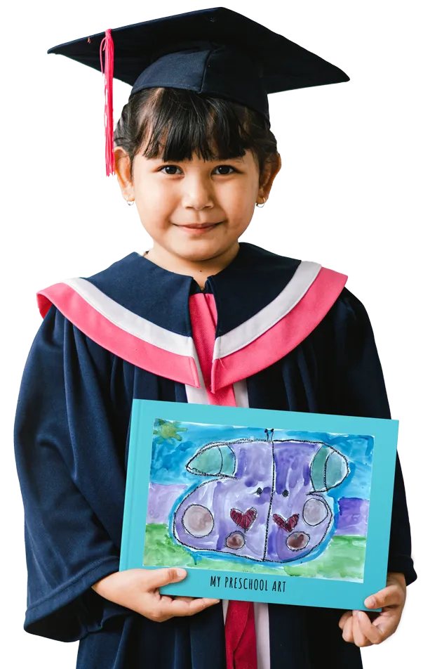 A preschool graduate with their end-of-year Scribble Art book